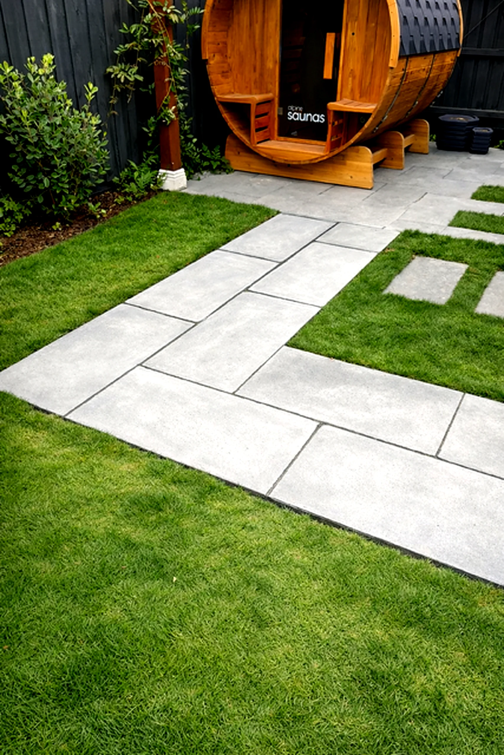 Bluestone paving pathway leading to barrel sauna with open turf Melbourne
